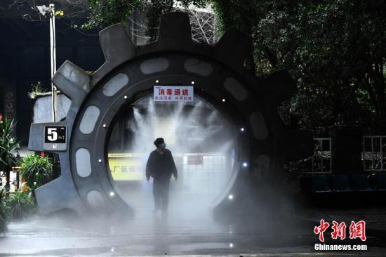 资料图:2月10日,为做好复工疫情防控工作,在位于重庆南岸区一企业大门处,企业安装了自动喷雾消毒装置,为进出企业的员工进行全身消毒杀菌。图为企业员工经过喷雾消毒处。<a target='_blank' rel=